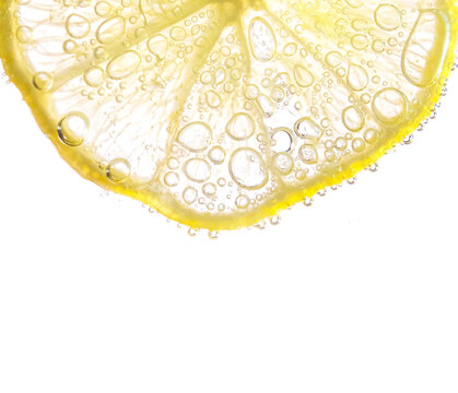 Juicy lime slices with bubbles under water isolated on white background. Yellow lemon slices pattern textured background.