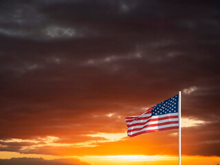 National flag of USA in focus. dramatic sunset sky out of focus. Copy space.
