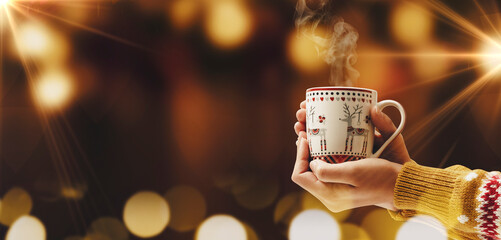 Woman having a hot chocolate in a Christmas cup