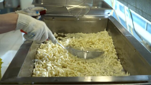 fry the dough in a deep fryer close-up