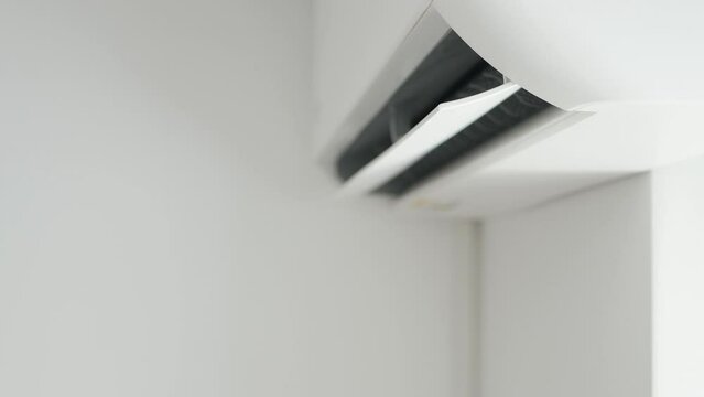 Air Conditioning Blowing Fresh Cool Air in the Office Changing the Room Temperature. Cooling Device Technology in Function. Split System. Shooting with an Air-Conditioner Working on a Hot Summer Day.