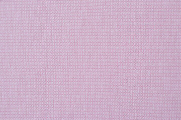 Fototapeta premium Delicate pink fabric with fine oblique knitting. Background for design and lettering.
