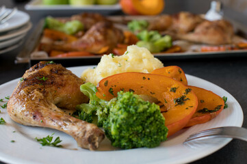 Plate with chicken, squat and mashed potatoes  on kitchen table