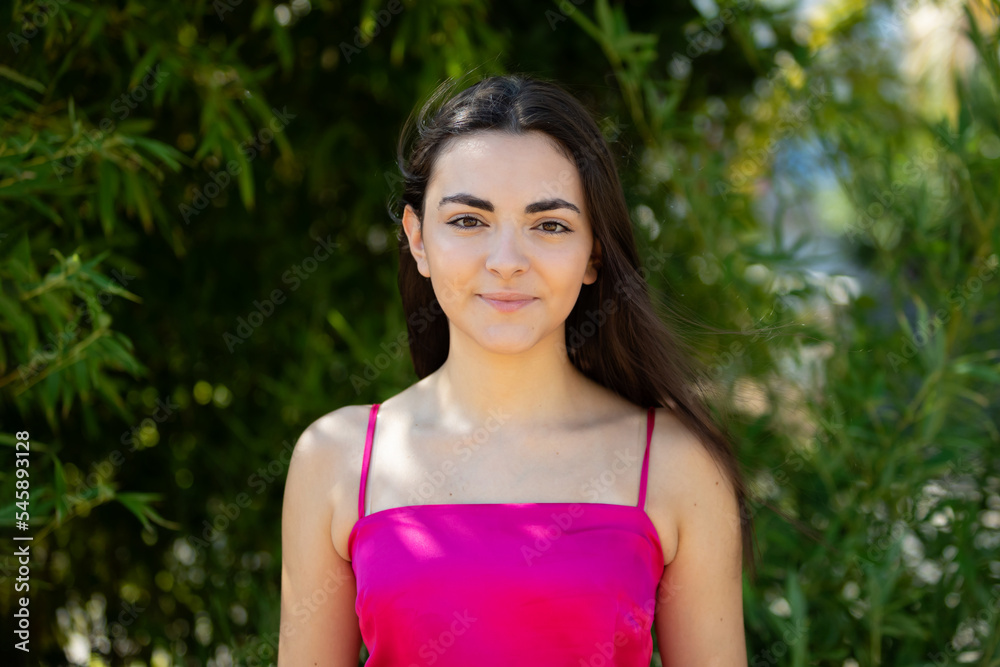 Canvas Prints Portrait of a happy lovely and beautiful Spanish young woman in a park.