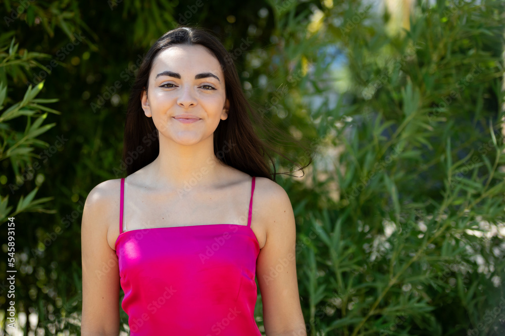 Canvas Prints Portrait of a happy lovely and beautiful Spanish young woman in a park.