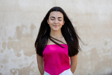 Fototapeta premium Portrait of a happy lovely and beautiful Spanish young woman in a park.