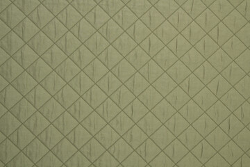 Fototapeta premium Quilted fabric green. The texture of the blanket.
