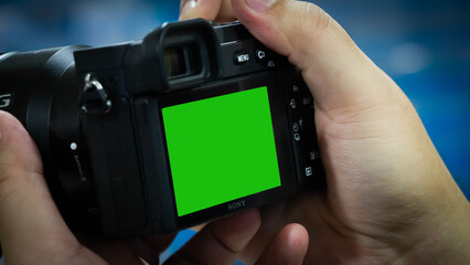 Camera with green screen on the background.