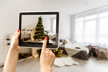 Hands holding tablet showing plans in finished room. Modern apartment. Technical drawing. Home...