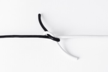 black and white cord tied in a knot in a symbol of tolerance