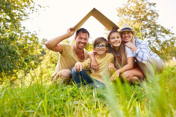 Family in a meadow with a roof over their heads