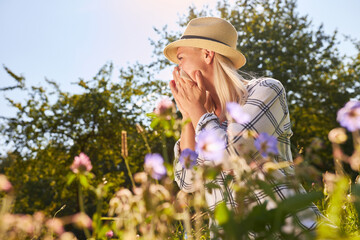 Woman with runny nose or hay fever when sneezing - obrazy, fototapety, plakaty