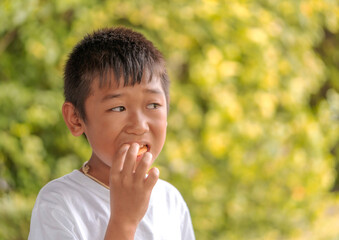 Portrait of cute boy eating crunchy snacks.