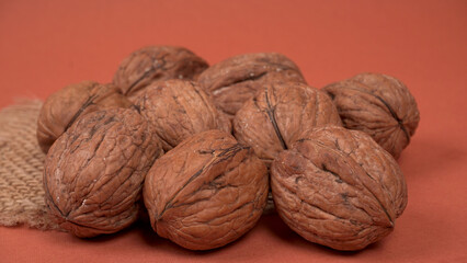 Closeup photo of a walnut seed in wooden bowl. Food that is good for brain and lower risk of heart disease.