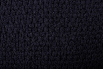 Fototapeta premium Knit black fabric texture, background or backdrop. Textile, scarf or sweater textured surface. Warm accessories, clothing, fashion concept