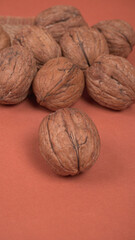 Closeup photo of a walnut seed in wooden bowl. Food that is good for brain and lower risk of heart disease.