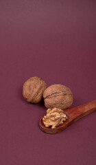 Closeup photo of a walnut seed in wooden bowl. Food that is good for brain and lower risk of heart disease.