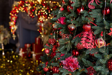 Fototapeta premium Close up of balls on Christmas tree. Bokeh garlands in the background. New Year and Christmas concept.