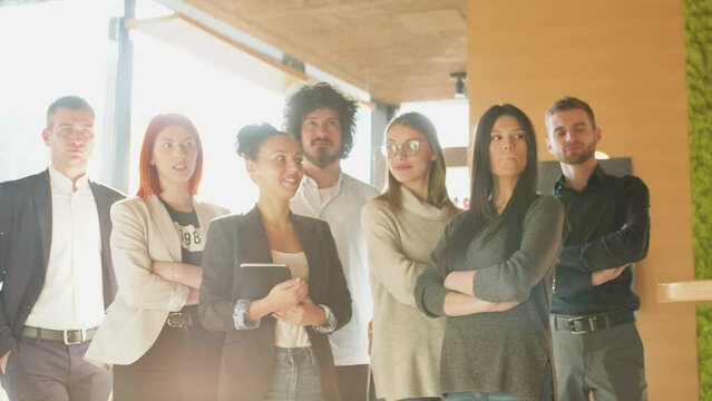 Bussiness team posing for a corporate photo. Group of successful young people standing together.