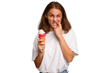 Young caucasian woman holding an ice cream isolated relaxed thinking about something looking at a copy space.
