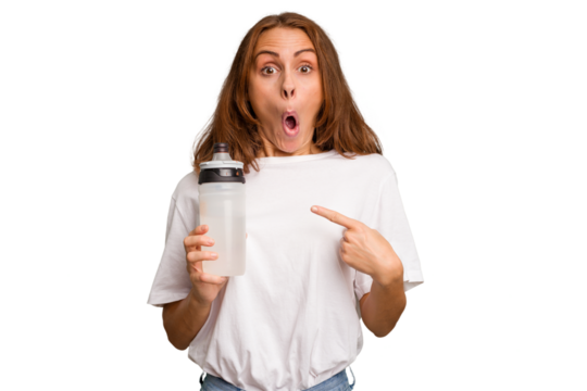 Young caucasian sport woman holding a bottle of water isolated pointing to the side