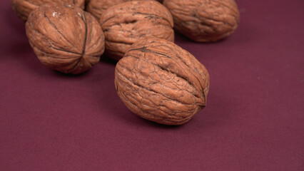Closeup photo of a walnut seed in wooden bowl. Food that is good for brain and lower risk of heart disease.