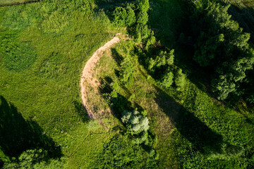 Aerial view of a sandy cliff in the middle of a green landscape