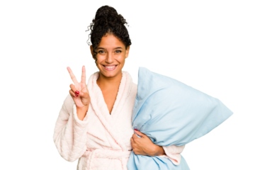 Young brazilian woman wearing a pajama holding a pillow isolated showing number two with fingers.