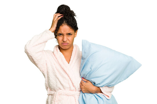 Young brazilian woman wearing a pajama holding a pillow isolated being shocked, she has remembered important meeting.