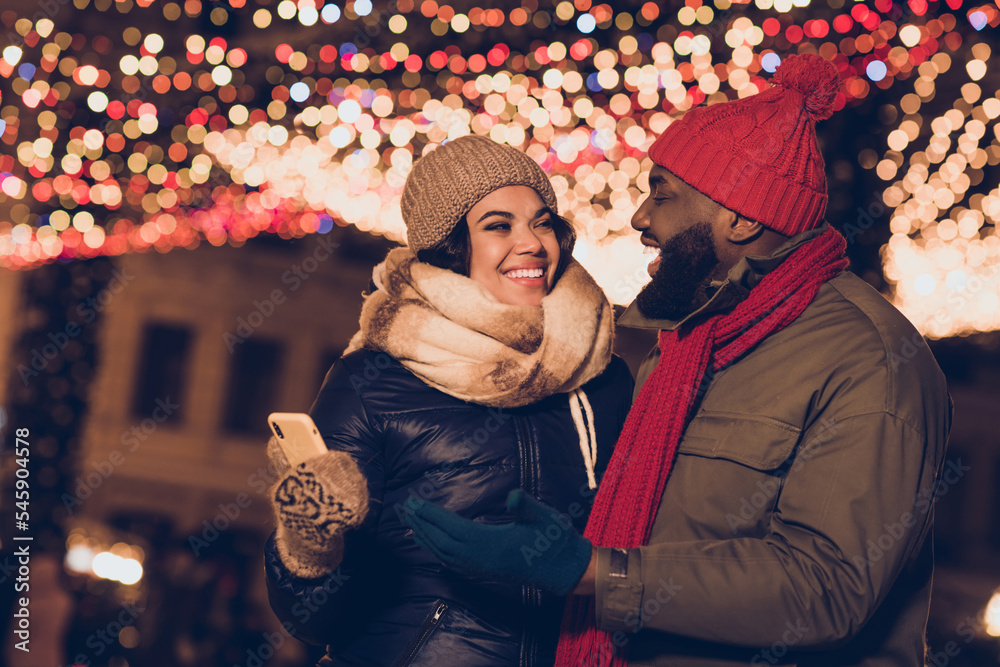 Canvas Prints Portrait of attractive affectionate cheerful couple spending festal day using device order eashop decorated street city urban outdoors