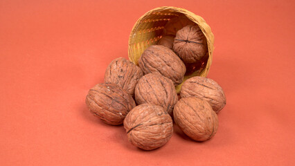 Closeup photo of a walnut seed in wooden bowl. Food that is good for brain and lower risk of heart disease.