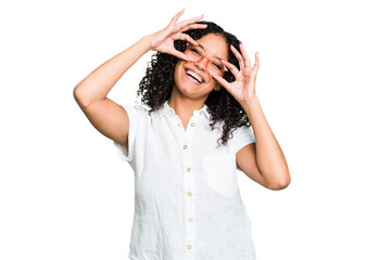 Young cute brazilian woman isolated showing okay sign over eyes
