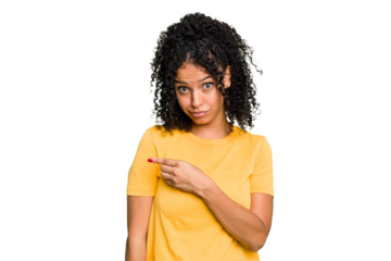 Young cute brazilian woman isolated smiling and pointing aside, showing something at blank space.