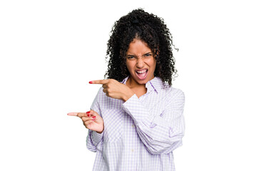 Young cute brazilian woman isolated pointing with forefingers to a copy space, expressing...