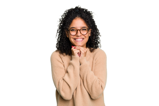 Young cute brazilian woman isolated keeps hands under chin, is looking happily aside.