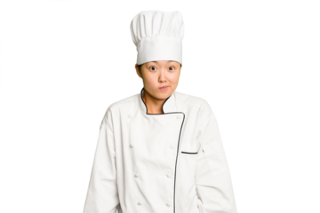 Young asian cook woman isolated shrugs shoulders and open eyes confused.