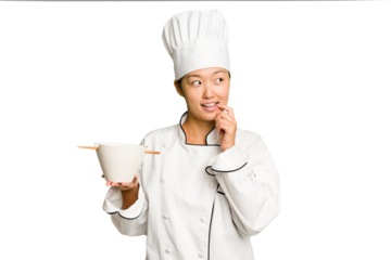 Young chef asian woman holding a bowl of ramen isolated relaxed thinking about something looking at a copy space.