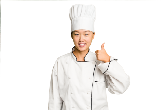 Young asian cook woman isolated smiling and raising thumb up