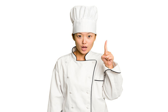 Young asian cook woman isolated having some great idea, concept of creativity.