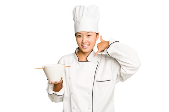 Young chef asian woman holding a bowl of ramen isolated showing a mobile phone call gesture with fingers.
