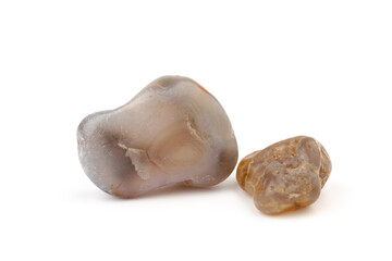 Multicolored gemstones, tumbled minerals. Bostwan agate of various sizes on a white background.