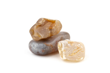 Multicolored gemstones, tumbled minerals. Bostwan agate of various sizes on a white background.