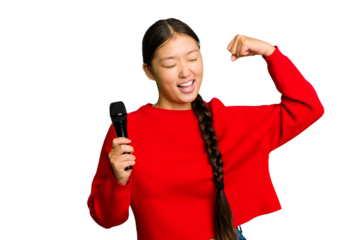 Young Chinese singer woman isolated raising fist after a victory, winner concept.