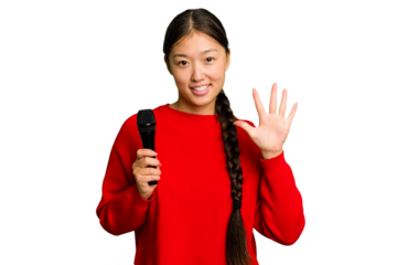 Young Chinese singer woman isolated smiling cheerful showing number five with fingers.