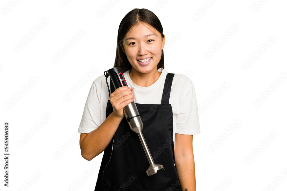 Wall mural young asian cook woman holding a blender isolated happy, smiling and cheerful.