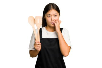 Young asian cook woman isolated biting fingernails, nervous and very anxious.