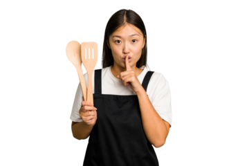 Young asian cook woman isolated keeping a secret or asking for silence.
