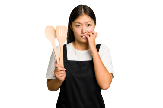 Young asian cook woman isolated biting fingernails, nervous and very anxious.