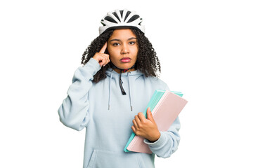 Young african american student woman wearing a helmet bike isolated pointing temple with finger, thinking, focused on a task.