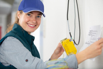 female electrician is smiling at the camera